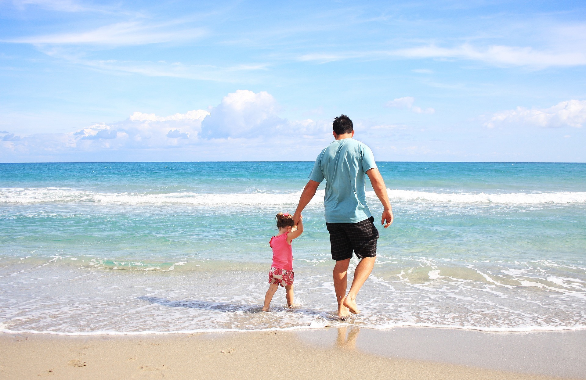 Man holding child's hand